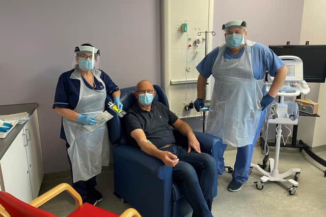 The first patient to receive the new treatment in Fife is flanked by Senior Charge Nurse, Val Turner (left), and Staff Nurse, Wilson Imrie (right).