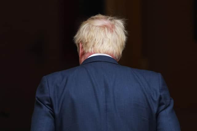 Prime Minister Boris Johnson returns inside after addressing the nation as he announces his resignation (Photo by Carl Court/Getty Images)