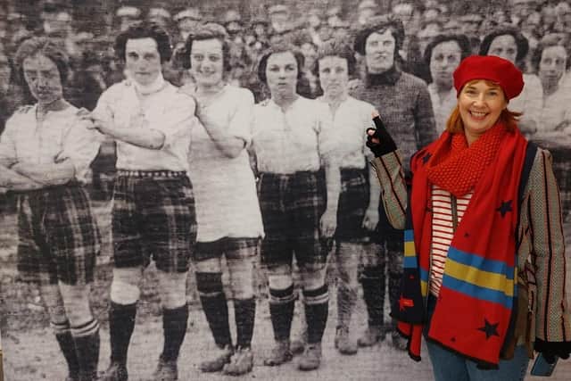 Carolyn Johnston, venue supervisor at Kirkcaldy Galleries, points out her footballing ‘superstar’ great-grandmother in one of the photographs in the exhibition.  (Pic: OnFife)