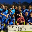 The banner says it all as Saints players celebrate promotion (Pic courtesy of St Andrews United)