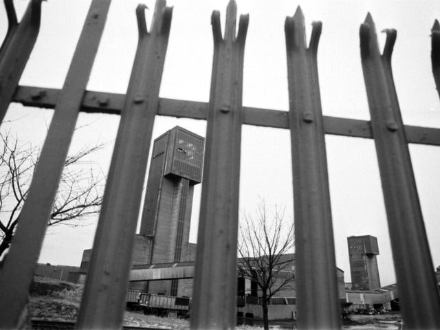 A view of the winding tower at Seafield colliery in Fife, seen through the spiked railings from 1988.
