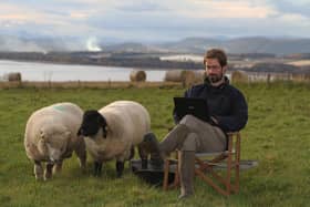 Farmer turned author James Oswald crafts his latest novel watched by two2 of his sheep (Pic: David Cruickshanks)