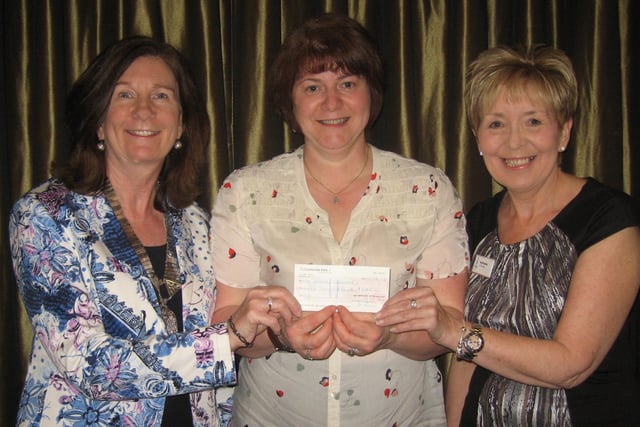 Soroptimist President Audrey Lumsden presenting a cheque for £2000 in the year 2000 to Fiona MacKay of Age Concern Glenrothes, with Incoming President Avril Eardley