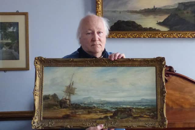 George McLauchlan with the oil painting which shows a sailing ship, aground on the foreshore adjacent to the Black Rock with the Edinburgh skyline in the background.