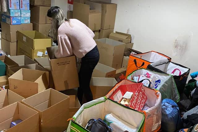 A member of staff sorting aid donations at Jezyk the Hedgehog store.