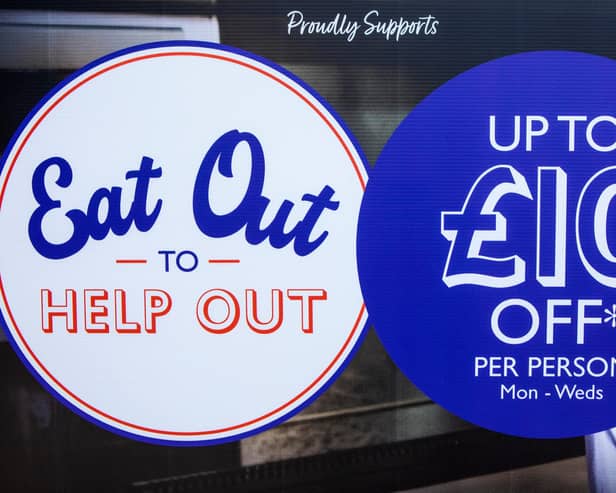 A sign displayed outside a restaurant promoting the Eat Out to Help Out scheme.