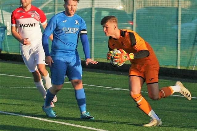 St Andrews goalkeeper Kyle Moran claims the ball with Nik Rendall looking on. Pic by John Stevenson