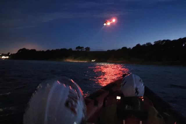 The Kinghorn RNLI crew at the scene of the Fife beach emergency with the helicopter hovering above (Pic: Kinghorn RNLI)