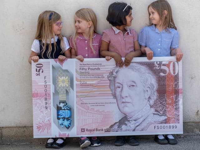 Pupils from Flora Stevenson Primary School in Edinburgh with the design for the bank's new £50 note which features an illustration of Scottish education pioneer Flora Stevenson (Photo: Royal Bank of Scotland/PA Wire).