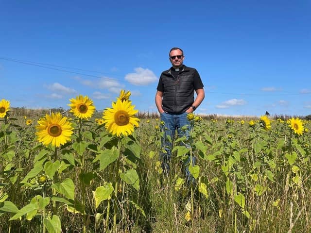 Rev Douglas Creighton.at the sunflower field where Claire  Pollock of Ardross Farm undertook the ambitious task to create a maze spelling out 'Hope'