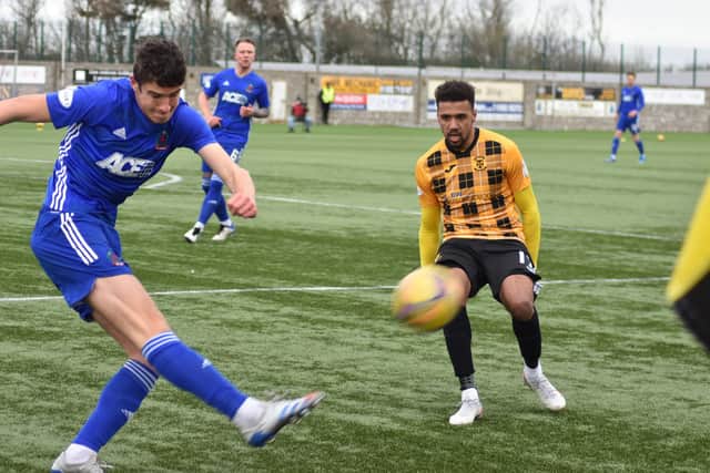 Cove clear their lines under pressure from Fife forward Nathan Austin. Pic by Kenny Mackay