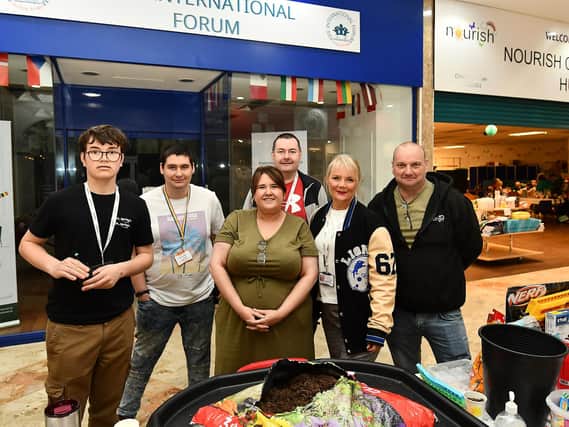 Lynne Scott, Nourish CEO with charity shop and community hub volunteers and managers at Saturday's celebrations.  (Pic: Fife Photo Agency)