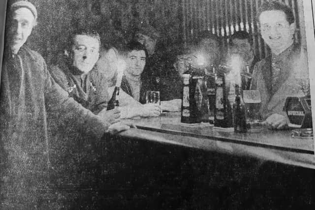 A pint by candlelight - with the lights off by order of the Government, these regulars at the Novar Bar in Kirkcaldy still managed to get a pint