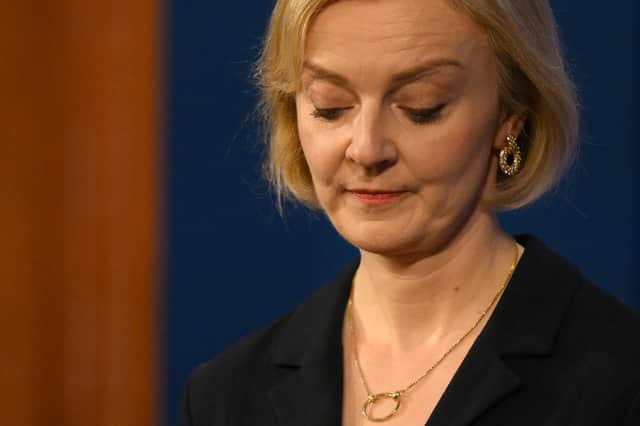 Britain's Prime Minister Liz Truss looks down during a press conference in the Downing Street Briefing Room (Photo by DANIEL LEAL/POOL/AFP via Getty Images)