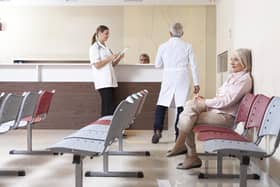 Doctors and patient discussing in hospital waiting room. (Shutterstock)