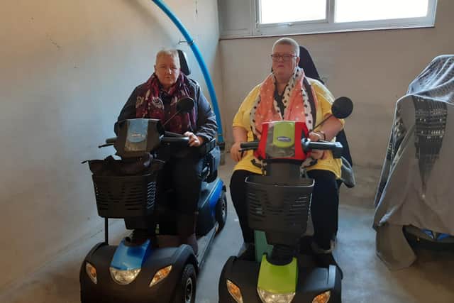Catherine and Angela have been told that they can no longer charge their scooters in the storage area.