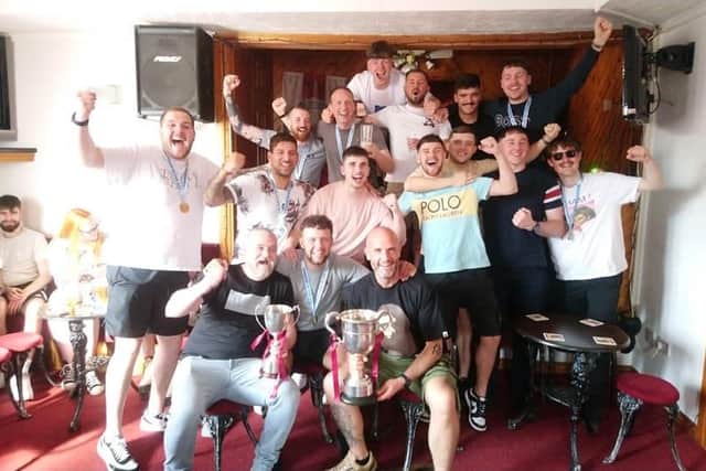 Jubilant Hearts players and management celebrate trophy double