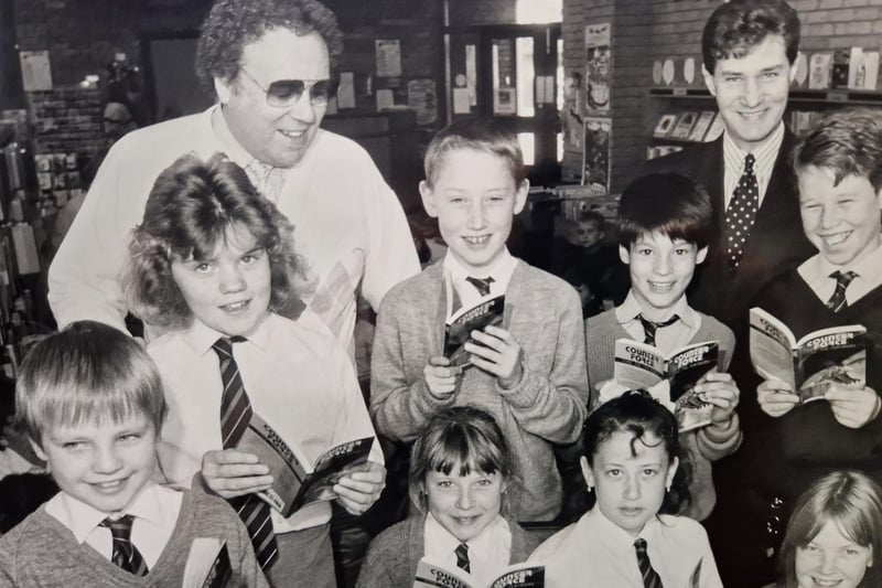 Authors Ian Cameron and George Erskine pictured in 1988 at Cadham Library in Glenrothes with P7 pupils from Collydean Primary School. Picture by David Cruickshanks, staff photographer, Glenrothes Gazette.