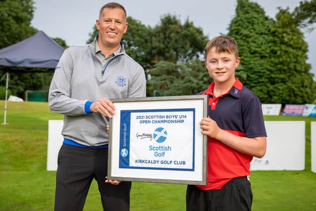 Cameron Mukherjee, winner of 2021's Scottish boys’ under-14 open golf championship, being presented with a certificate by Kirkcaldy Golf Club champion Fraser Thomson (Photo: Scottish Golf)