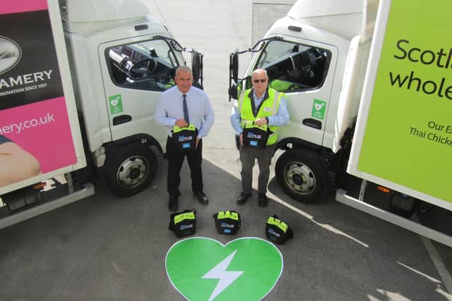 Richard Wishart, transport manger (left) and Mike Canning, warehouse manager at Fife Creamery with just a few of the 43 AEDs (Pic: Submitted)