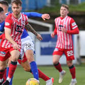 Brad Spencer of Raith Rovers evades Queen of the South scorer Max Johnston as Ethan Ross, right, watches on (picture by Dave Johnston)