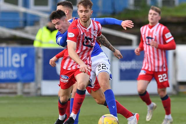 Brad Spencer of Raith Rovers evades Queen of the South scorer Max Johnston as Ethan Ross, right, watches on (picture by Dave Johnston)