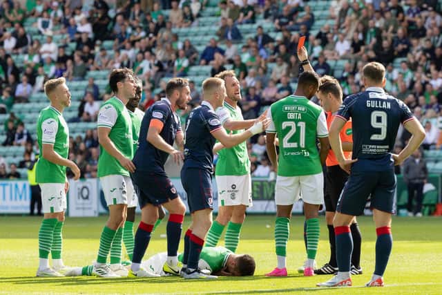 EDINBURGH, SCOTLAND - AUGUST 20: Referee Nick Walsh shows Raith Rovers' Liam Dick a red card during a Viaplay Cup Round of Sixteen match between Hibernian and Raith Rovers at Easter Road, on August 20, 2023, in Edinburgh, Scotland. (Photo by Ross Parker / SNS Group)