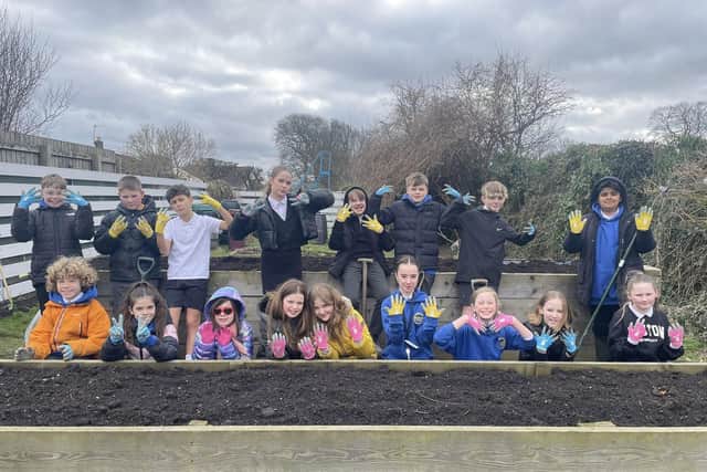 Children showing off their new gardening gloves purchased by CLP Nature Action thanks to the previous round of Seed &Development Funding. (Pic: CLP Nature Action)