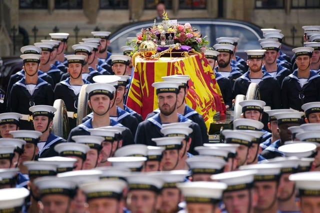 The State Gun Carriage carries the coffin of Queen Elizabeth II, draped in the Royal Standard with the Imperial State Crown and the Sovereign's orb and sceptre with a message from King Charles III