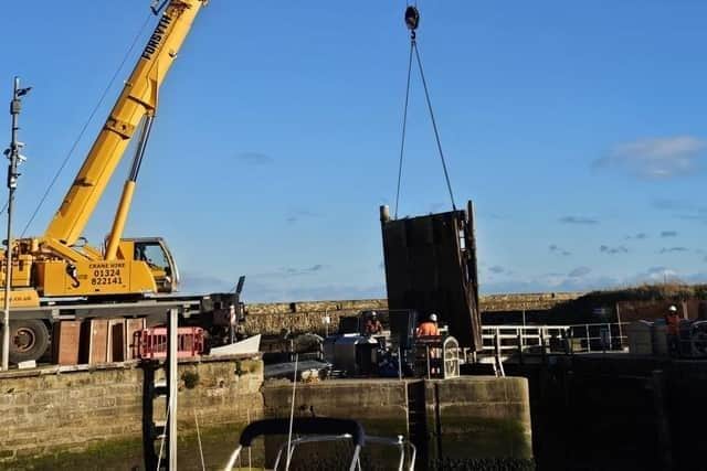 Fife Harbour gates are removed for repairs.