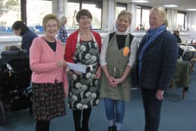 The photo shows from left Careen Lindsay, Art Volunteering Co-ordinator of the Arts Society, handing the cheque to Judy and Dot Black, with Society Vice Chair Ann Cumming on the right.