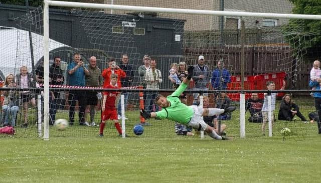 Ben Anthony's crucial winning penalty hits the back of the net.