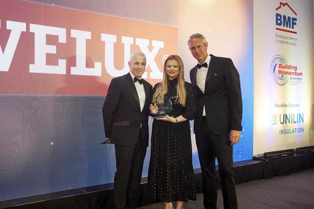 Rachel Dennett at Velux receives the BMF Supplier Engagement Award 2023 from Chris Hayward (left) with awards host Mark Foster. (Pic: Submitted)