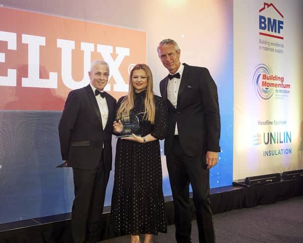 Rachel Dennett at Velux receives the BMF Supplier Engagement Award 2023 from Chris Hayward (left) with awards host Mark Foster. (Pic: Submitted)