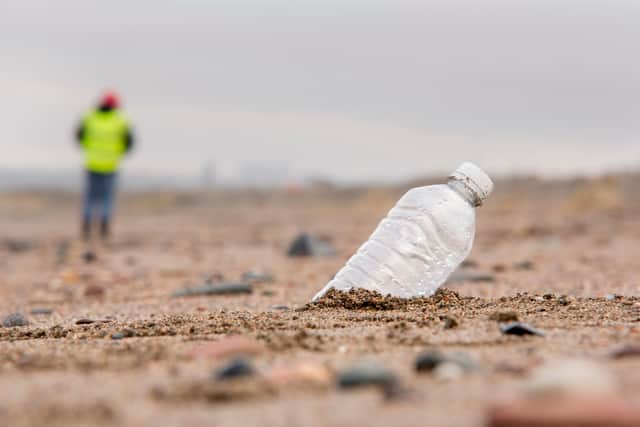 A volunteer litter picking on Kirkcaldy's Pathhead Sands.