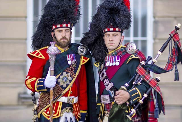Identical twins, Sergeants Peter and James Muir, lead as the Scots pipe and drum majors at the Royal Edinburgh Military Tattoo.