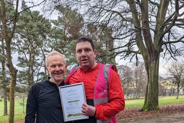 Douglas Murray gets certificate from run director Andrew Aird for completing his 250th Kirkcaldy Parkrun
