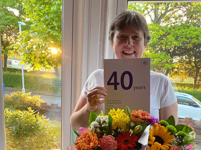 Elizabeth after being given flowers to mark her long service with BT.