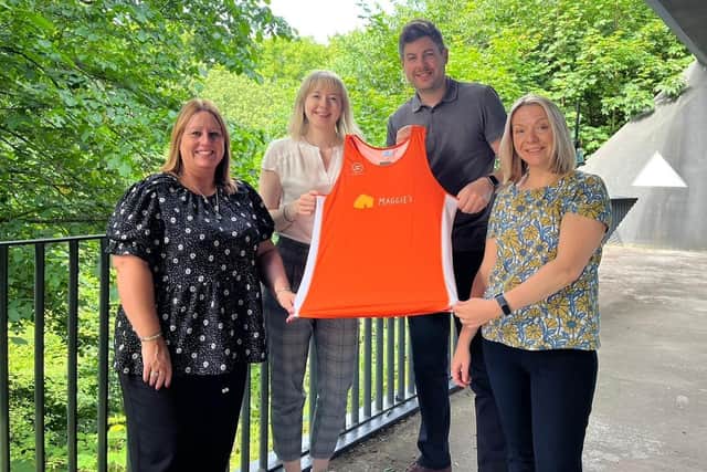 Maggie’s Fife staff proudly show off one of their running vests to be given to all runners in the 2022 Kirkcaldy Parks Festival. Pictured (L-R) Debbie McCrae, Hannah Grüneberg, Adam Kent and Jen Ewing.