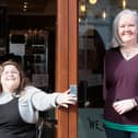 Erin Watson (left) and Zest owner Lisa Cathro try the new disabled push pad on the front door.