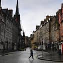Members of the public walk through a deserted Edinburgh City Centre on Monday ahead of the national lockdown beginning