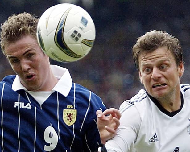 Kenny Miller with Germany's Christian Woerns in 2003 game (Pic Frank Augstein)