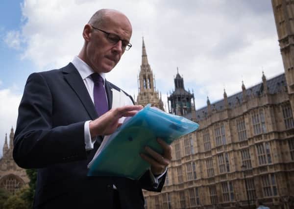 John Swinney has said the UK government could scale back planned cuts and still meet targets. Picture: PA