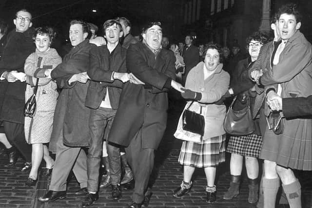 Scots traditionally sing Auld Lang's Syne after the bells at New Year. Pic: Albert Jordan