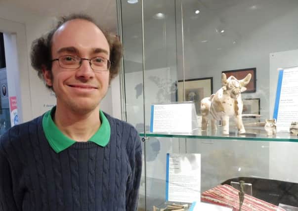 Matthew Sheard, learning & access curator at the University of St Andrews is pictured at the One World exhibition in MUSA, standing beside the PucarÃ¡ bull .