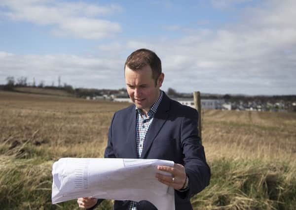St Andrews councillor Brian Thomson looks at plans for the new Madras College at the Pipeland Farm site.