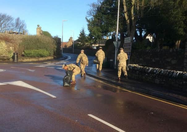 SCOTS DG soldiers headed out into Leuchars village to help clean up debris and litter after storm Gertrude swept across Scotland last night.