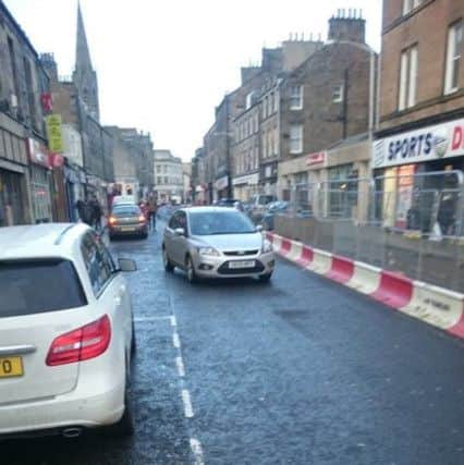 A car driving the wrong way along Kirkcaldy High Street's west end during roadworks.