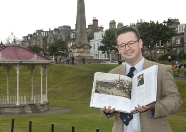 Roger McStravick in St Andrews with  his book, St Andrews: In the Footsteps of Old Tom Morris.