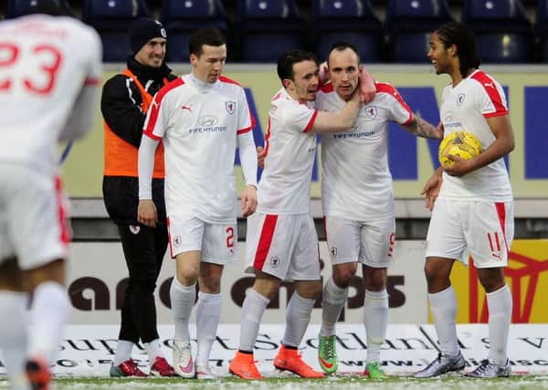 Mark Stewart is congratulated by his team mates after his goal earned Raith a point. Pic: Michael Gillen